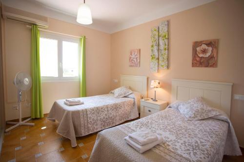 穆罗海滩Casa Albufera的一间卧室设有两张床和窗户。