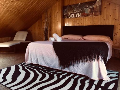 塞尼塞罗Villa turística Camina y Rioja的一张位于带斑马地毯的木制房间内的床铺