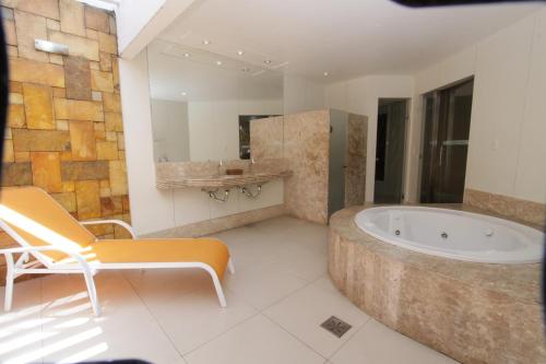 纳塔尔拉鲁利托拉诺特汽车旅馆（仅限成人）的带浴缸和盥洗盆的大浴室