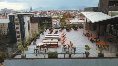 墨西哥城Hotel Fontan Reforma Centro Historico的大楼内带桌椅的户外庭院。