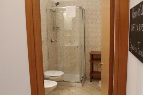 特拉尼Colonna Rooms & apartment的带淋浴、卫生间和盥洗盆的浴室