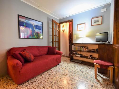 威尼斯Apartment Casa San Vio by Interhome的客厅配有红色沙发和电视