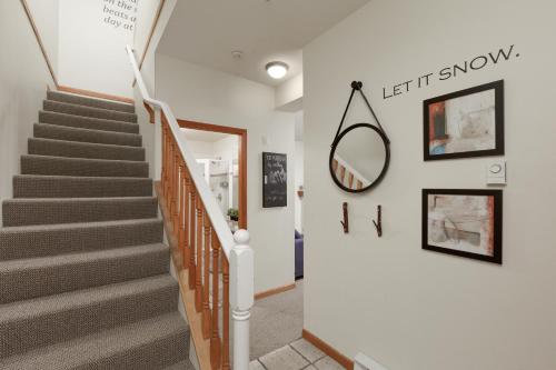 惠斯勒NorthStar by Cozystay Signature Whistler的走廊上设有楼梯,墙上设有镜子