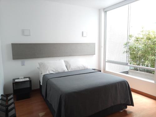 利马3B巴兰科基础别致住宿加早餐酒店的一间卧室设有一张床和一个大窗户