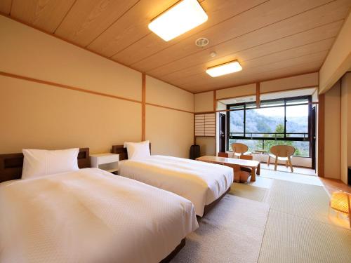 Hot Spring Inn Hakone Suisen客房内的一张或多张床位