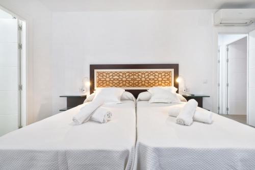 科尔多瓦Tejón y Marín, nuevo apartamento en casco antigüo的卧室配有2张白色床和白色枕头