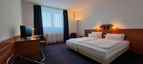 eXo Square Heidelberg/Schwetzingen - by SuperFly Hotels客房内的一张或多张床位