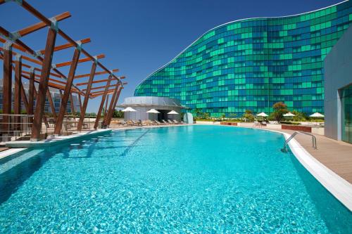 阿布扎比Millennium Al Rawdah Hotel的大楼前的大型游泳池