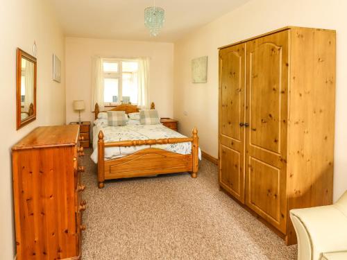 巴利巴宁Moybella Lodge的一间带两张床和大型木制橱柜的卧室