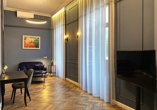 布达佩斯Hotel Rumor的客厅配有桌子和电视