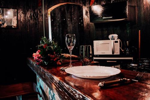 彼得罗波利斯Pipa Merlot的一张桌子,上面放着盘子和一杯葡萄酒