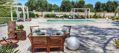 利扎诺B&B Sogno Salentino的一个带两把椅子的庭院和一个游泳池