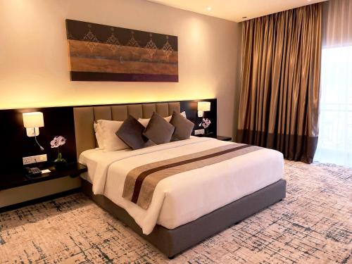 关丹Grand Darul Makmur Hotel Kuantan的一间卧室,卧室内配有一张大床