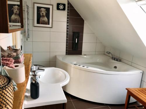 赫加奈斯Villa Lindell的浴室配有白色浴缸和水槽