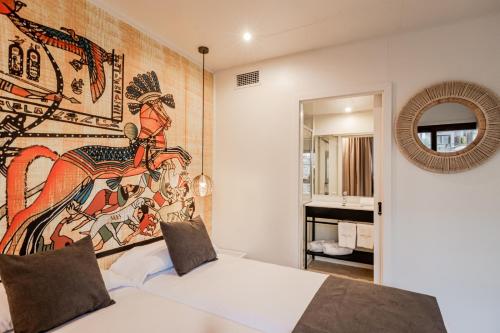 贝尼多姆Grand Luxor Village的卧室配有白色床,墙上挂有壁画