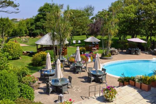 圣萨维尔吉姆塞农舍酒店的一个带桌椅的户外庭院和一个游泳池
