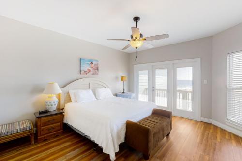 摩根堡Lotsa Dunes by Meyer Vacation Rentals的卧室配有白色的床和吊扇