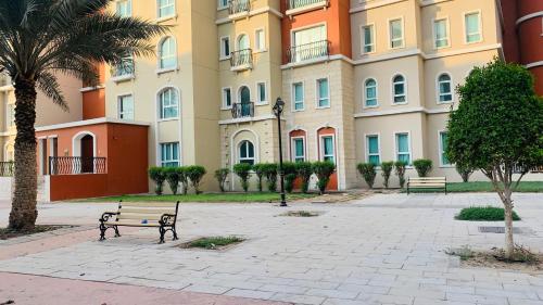 迪拜Expo Backpackers的建筑前有长椅的公园