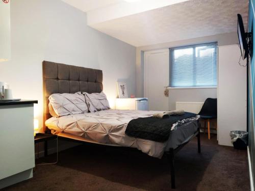 曼彻斯特Bankwell Guest House的一间卧室配有一张带床头板的床和窗户