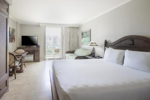 檀香山Luana Waikiki #710的卧室配有一张白色大床和电视。
