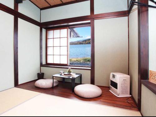 山中湖村Guest House Zen的客房设有带桌子和微波炉的窗户。
