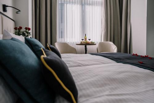 克拉科夫DReAM Boutique Residence的一间卧室配有一张带蓝色枕头的床和一张桌子