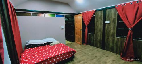 阿罗士打Bungalow Mat Hj Limah的卧室配有红色和白色的床和窗帘