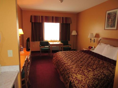 Warsaw华沙帕克菲尔德酒店的配有一张床、一张书桌和一扇窗户的酒店客房