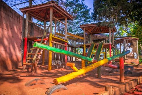 Campos GeraisPousada Café da Roça的泥土上运动场,有五颜六色的游戏设备