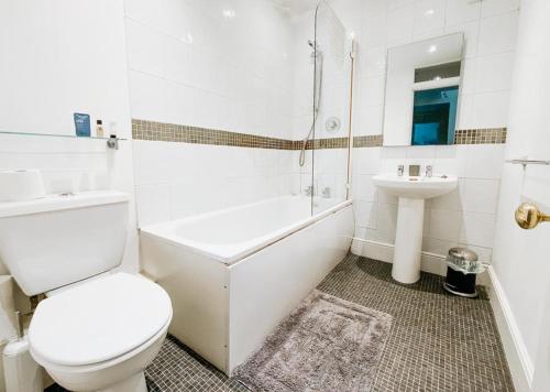 肯德尔SUNNYSIDE APARTMENT - Spacious 2 Bedroom Ground Floor with Free Parking In Kendal, Cumbria的白色的浴室设有卫生间和水槽。