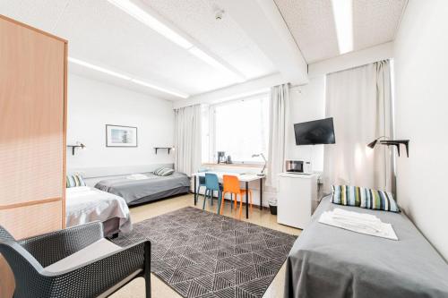 埃斯波埃斯波奥塔涅米奥卢弗里农旅馆的酒店客房设有两张床和一张桌子。