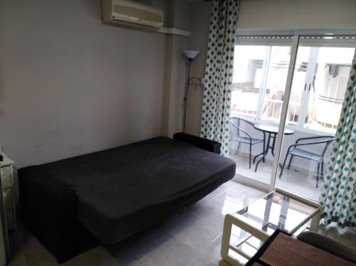 托雷维耶哈Apartament Goleta的小房间设有一张床和一张桌子及椅子