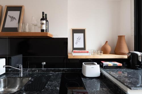 科尔多瓦Stay Suites的厨房配有带烤面包机和酒杯的吧台