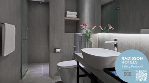 普特拉贾亚Park Inn by Radisson Putrajaya的浴室配有白色卫生间和盥洗盆。