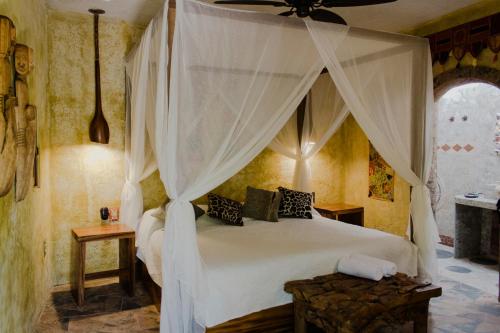 阿吉吉克Mandala Thai的一间卧室配有一张带天蓬的白色床