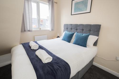 MonkwearmouthLuke Stays - Finsbury Street的卧室配有带蓝色枕头的大型白色床