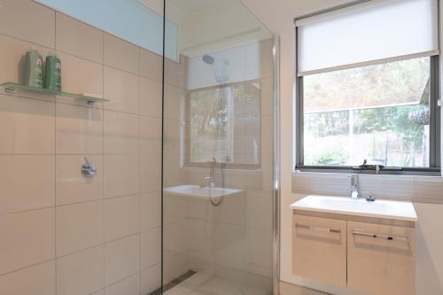Alonnah布鲁尼岛休闲度假酒店的带淋浴、盥洗盆和镜子的浴室