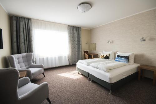 维克迪霍拉里酒店的配有一张床和一把椅子的酒店客房