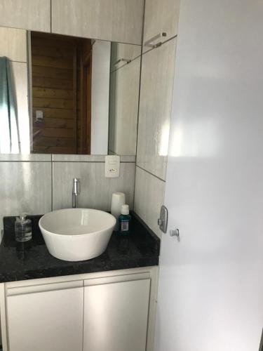德尔菲诺波利斯Casa de Madeira的浴室设有白色水槽和镜子