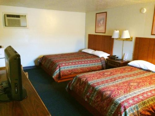 埃奇伍德Motel Edgewood的酒店客房设有两张床和电视。