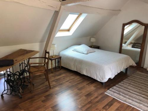 罗莫朗坦Le Grand Appartement - 90m2- 2 chb , 1 mezzanine - 6pers的一间卧室配有一张床、一张桌子和一面镜子