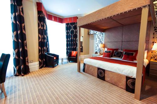 伊斯特布恩约克大厦贝斯特韦斯特酒店的酒店客房设有一张带天蓬的大床