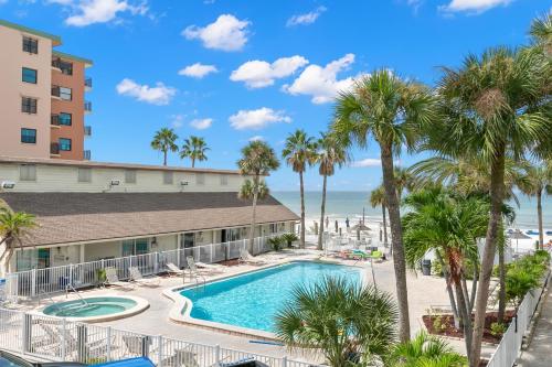 圣徒皮特海滩Grand Shores West的享有棕榈树和大海的度假村游泳池的景色