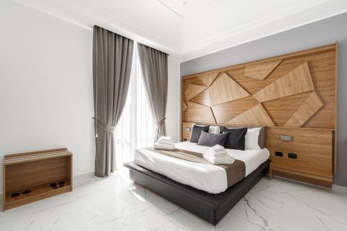 那不勒斯Sant'Angelo Suites的一间卧室配有一张大床和木制床头板