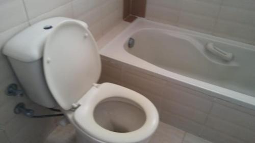 Dawwār ‘Abd al Qādir Qāsimشاليه مرقيا بالساحل الشمالي صف اول بحر的浴室配有白色卫生间和浴缸。