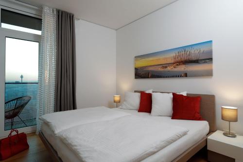 维也纳Triiiple Suites Level 21 mit Balkon und Tiefgarage的白色的卧室设有一张大床和一个窗户