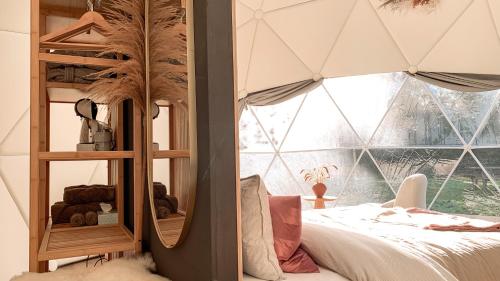 科克赛德Romantische glamping dome Koksijde - Duiniek的一间卧室设有一张床和一个大窗户