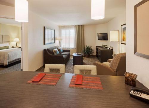 沃思堡Sonesta Simply Suites Fort Worth的酒店客房设有餐桌和客厅。