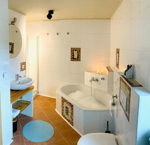 Muhr amSeeHaus am See的带浴缸、卫生间和盥洗盆的浴室
