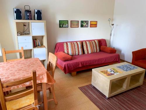 StahlbrodeFerienbungalow 182的客厅配有红色的沙发和桌子